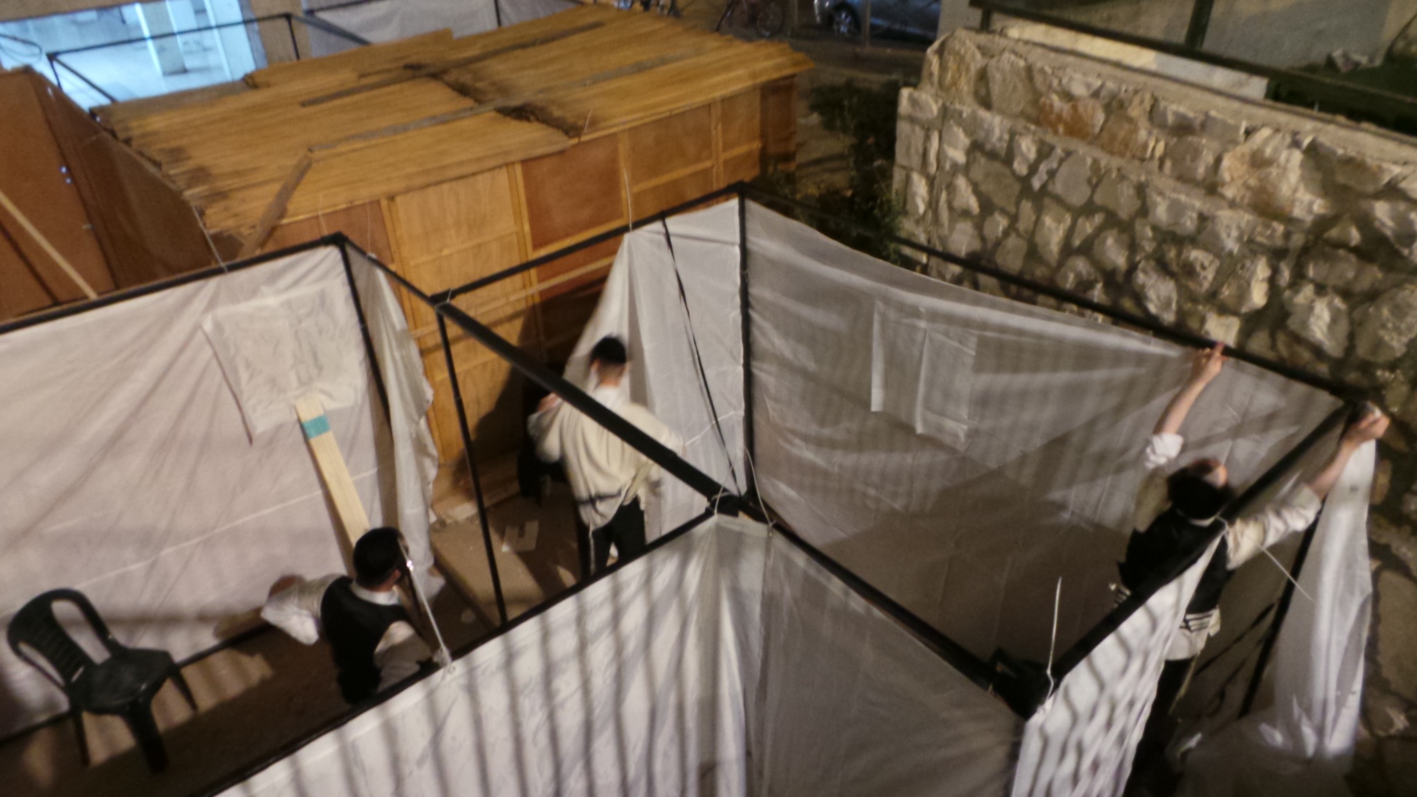 The sukkah being assembled before Yom Tov