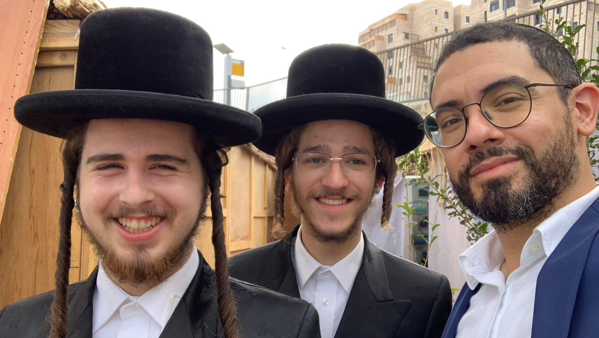 Guests together outside the sukkah during Chol Hamoed
