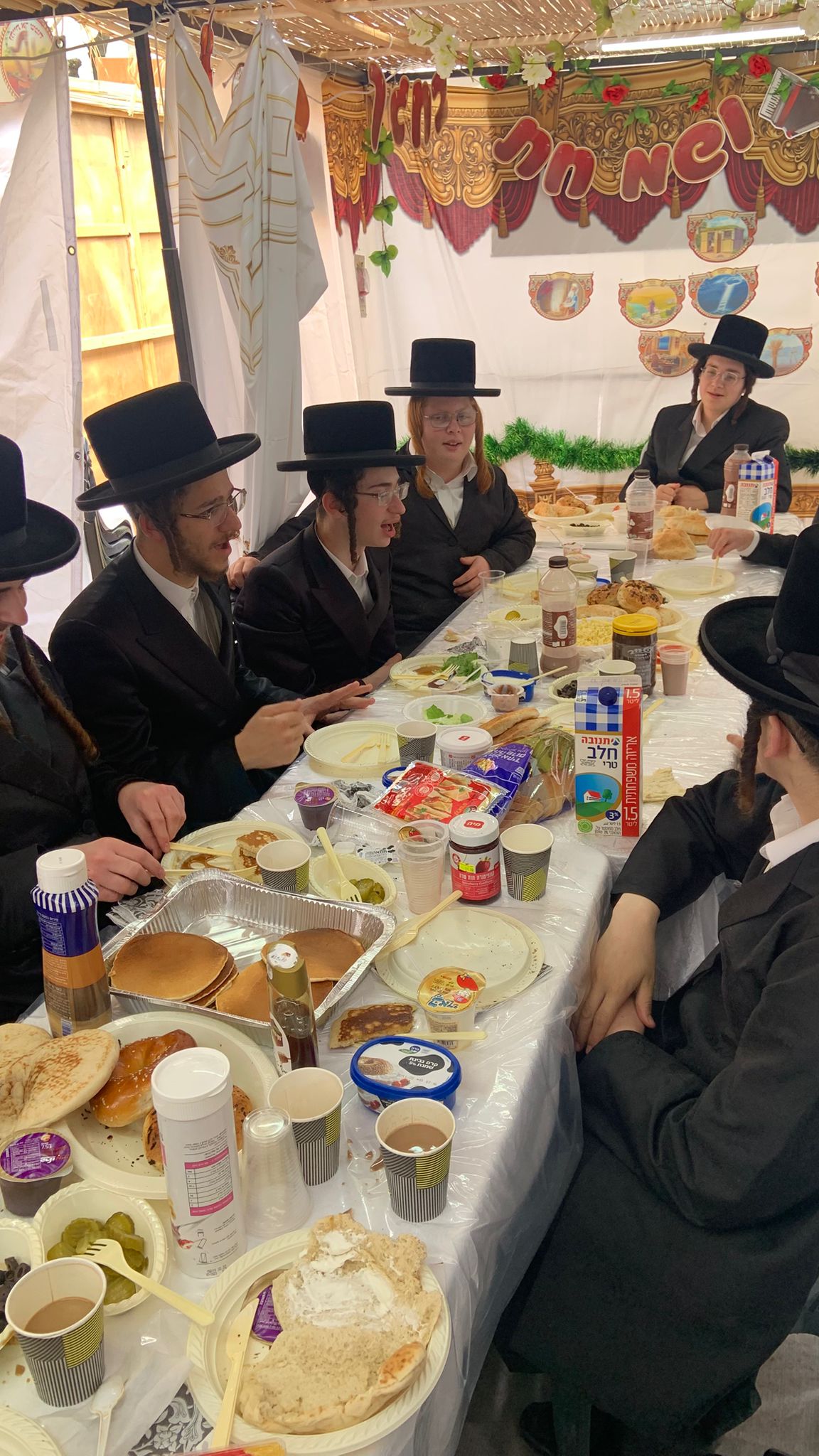 Guests singing together during a Chol Hamoed Sukkos gathering