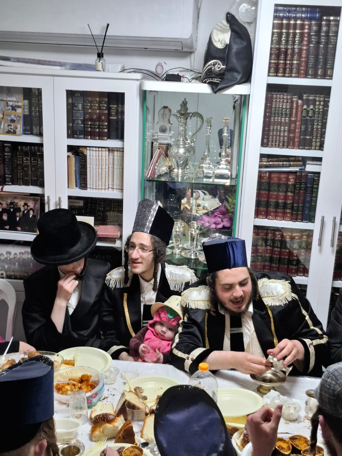 Bochurim gathered around the table during the Purim seudah